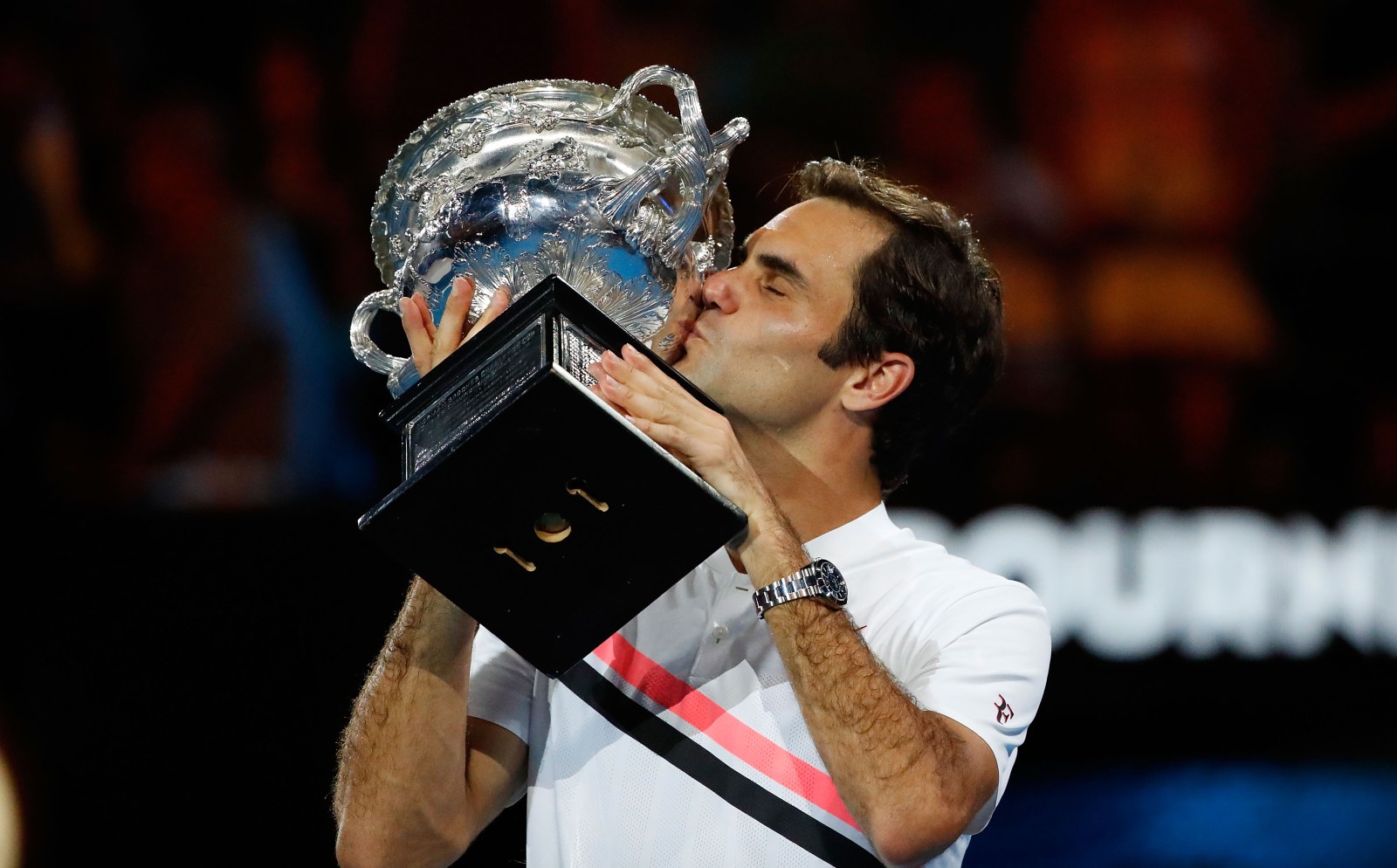 Roger Federer holding the Australian Open trophy in 2018