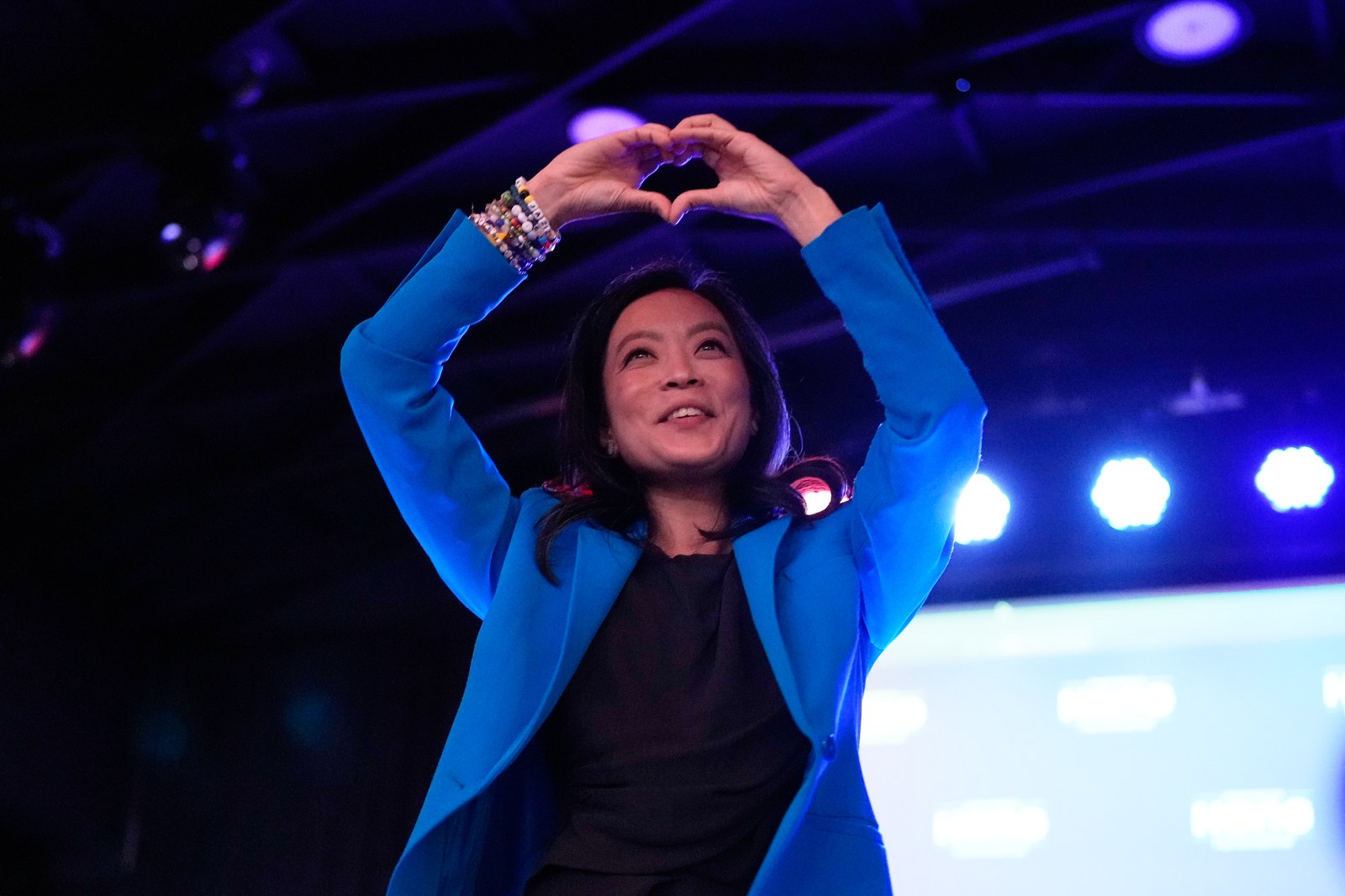Francesca Hong making a heart gesture to supporters at her election night watch party