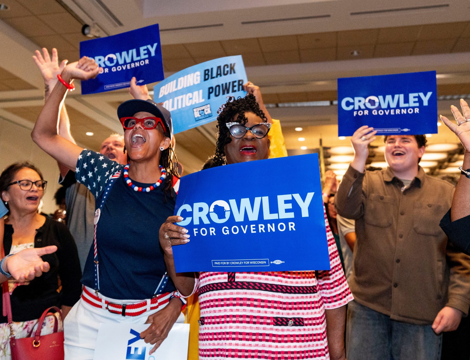 Rep. Gwen Moore cheering with David Crowley supporters at an election night party in Milwaukee