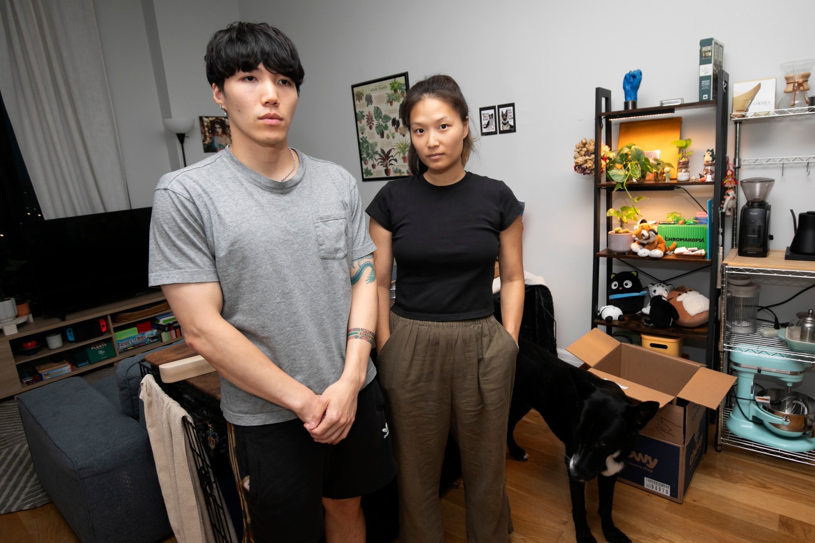 Bill and Yelim Kim standing in their Long Island City apartment